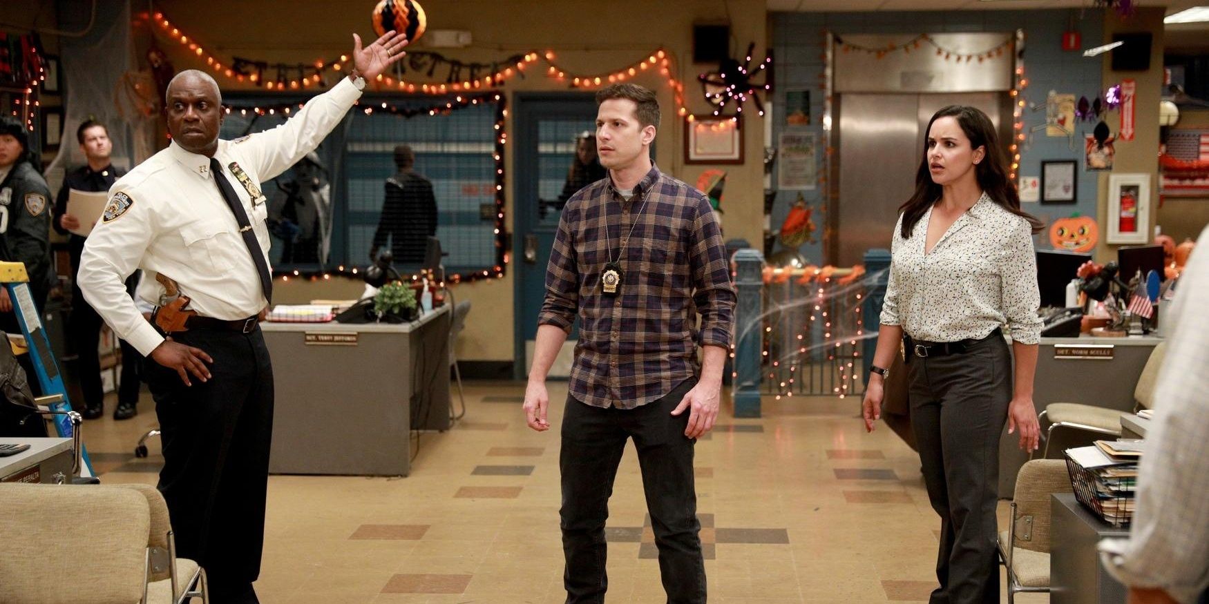 Holt, Peralta, and Santiago in the office with Halloween decorations in Brooklyn 99