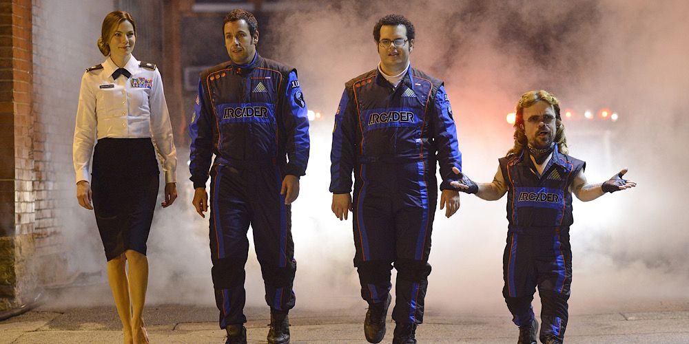 Michelle Monaghan, Adam Sandler, Josh Gad and Peter Dinklage walking in uniforms in Pixels