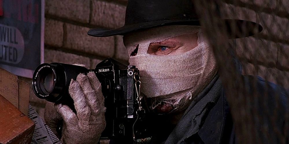 Liam Neeson as Darkman using a camera