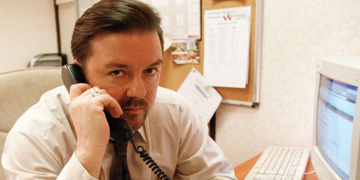David Brent holding a phone in The Office