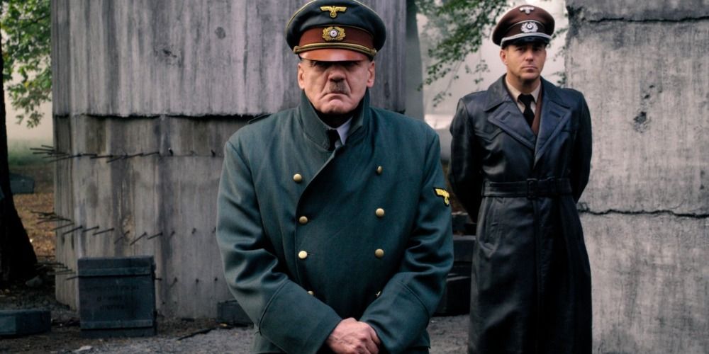 Adolf Hitler standing in front of a soldier in Downfall (2004).