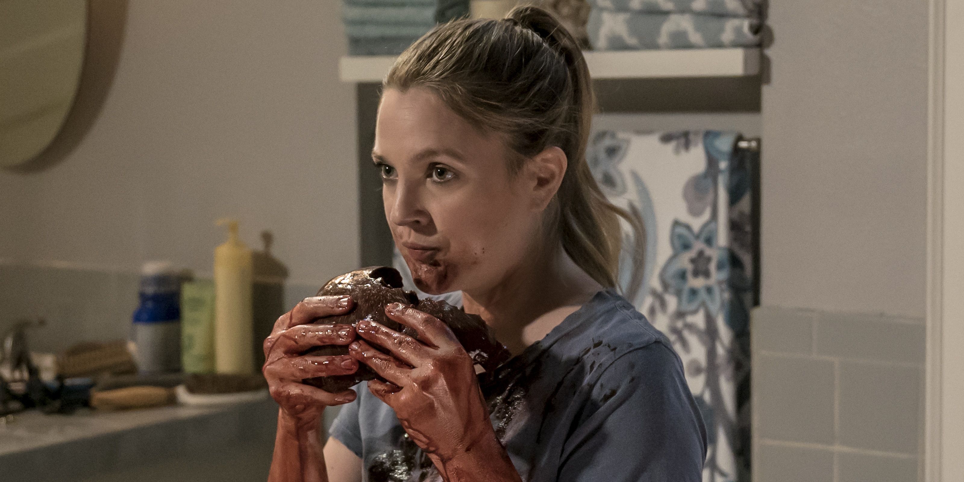 Drew Barrymore in Santa Clarita Diet, eating something with blood all over her hands.