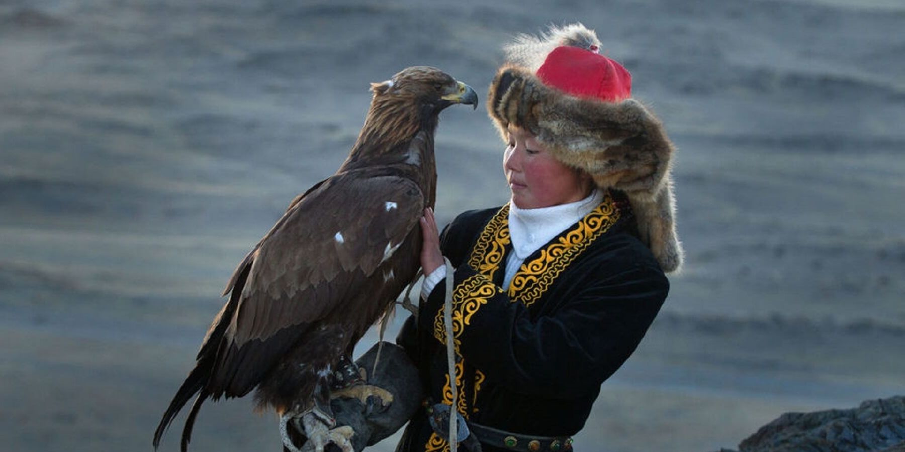 eagle held by woman in fur hat