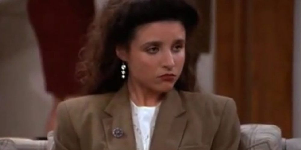 Elaine Benes sitting on couch at party on Seinfeld