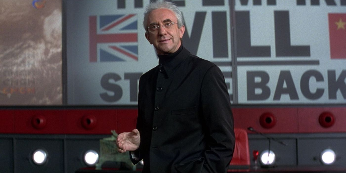Jonathan Pryce as Elliot Carver at a press conference in Tomorrow Never Dies