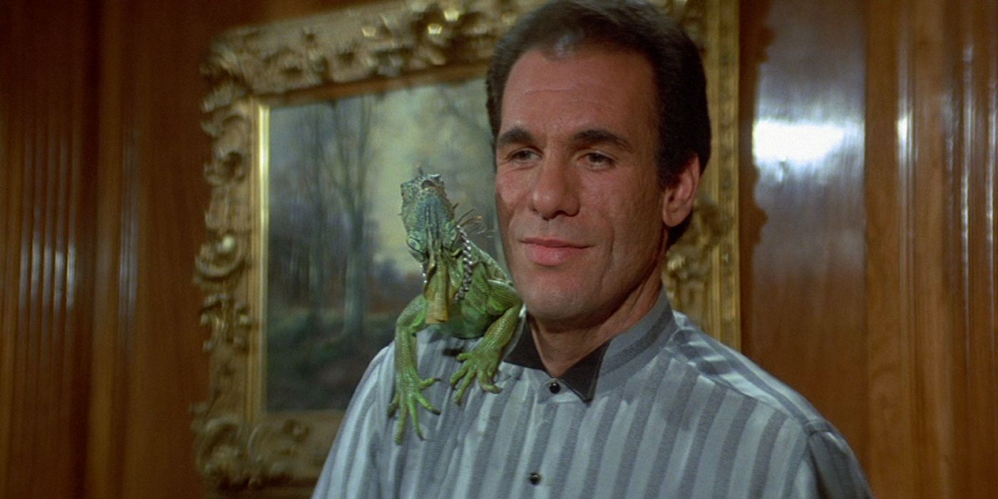 Franz Sanchez smiling with an iguana on his shoulder in License to Kill