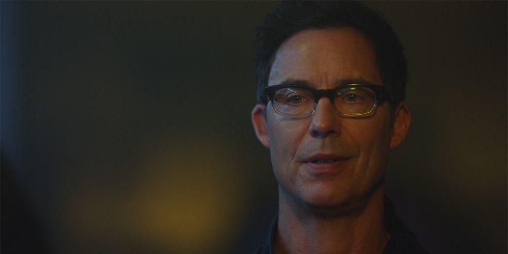 A version of Harrison Wells stares