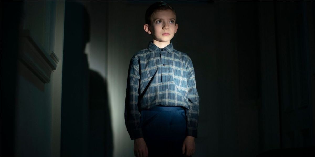 Child standing in the dark