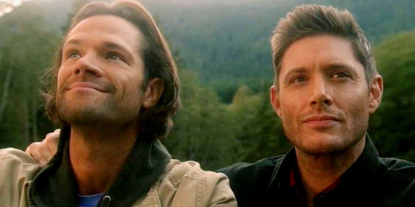 Dean and Sam standing and smiling together in Supernatural