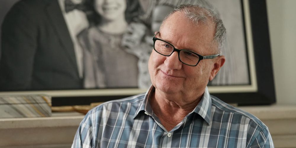 Jay smiling off screen on Modern Family