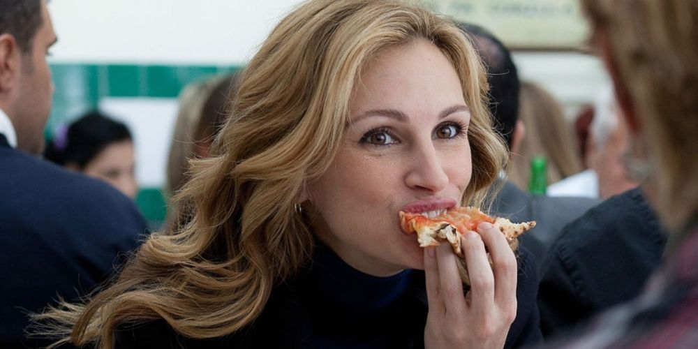Elizabeth Gilbert eating pizza in Italy in Eat Pray Love