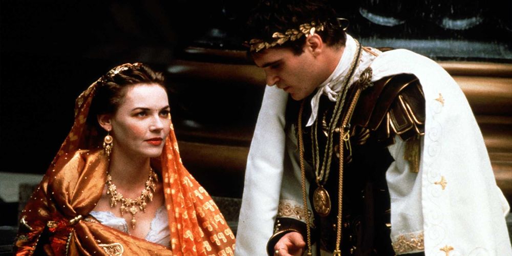 in senate house, commodus leans in to lucilla