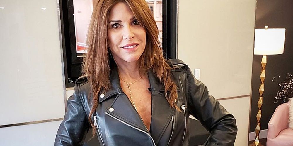 Lynne Curtin from RHOC wearing a leather jacket and smiling 