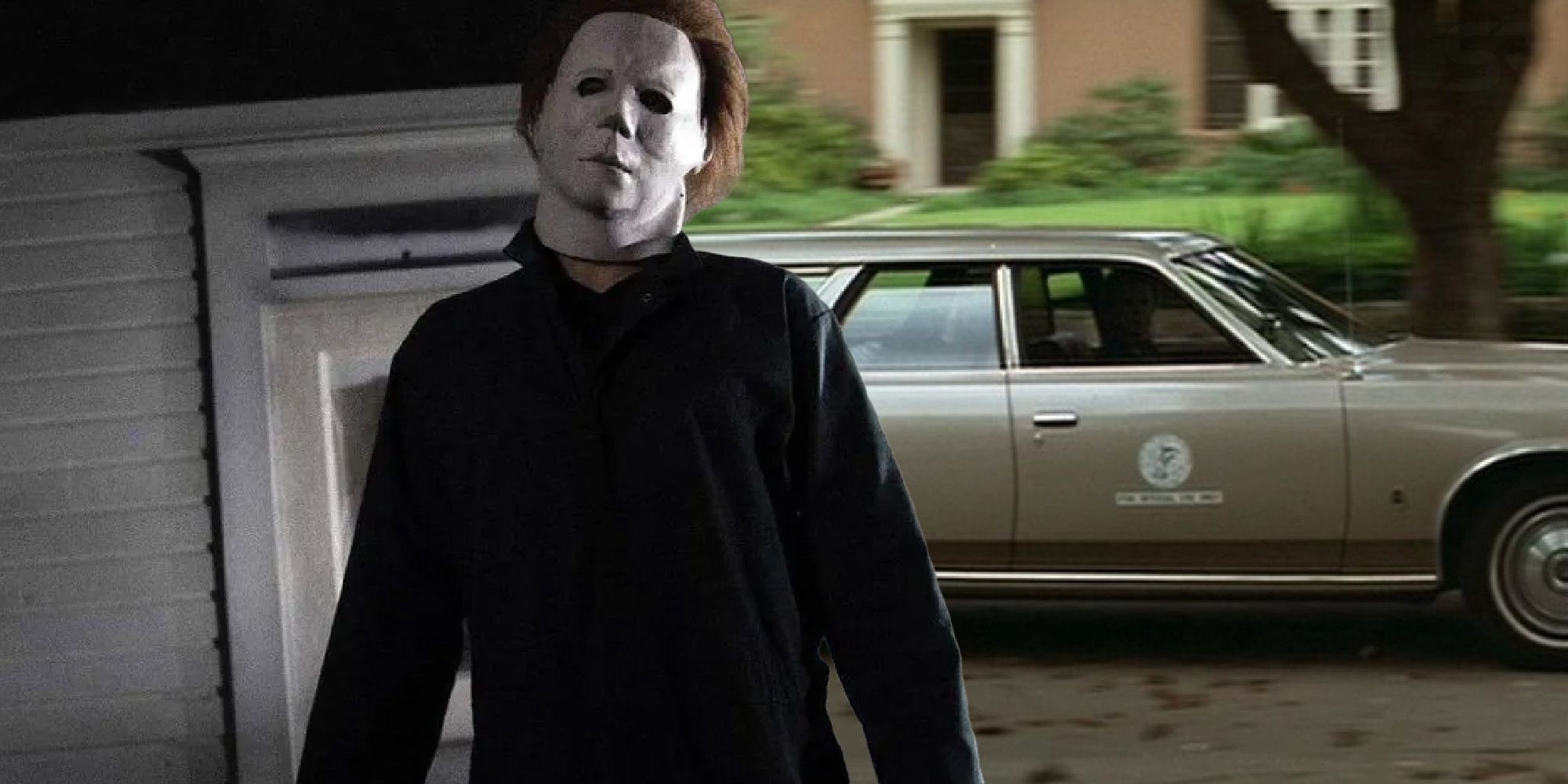 Michael Myers standing outside in front of a car in Halloween