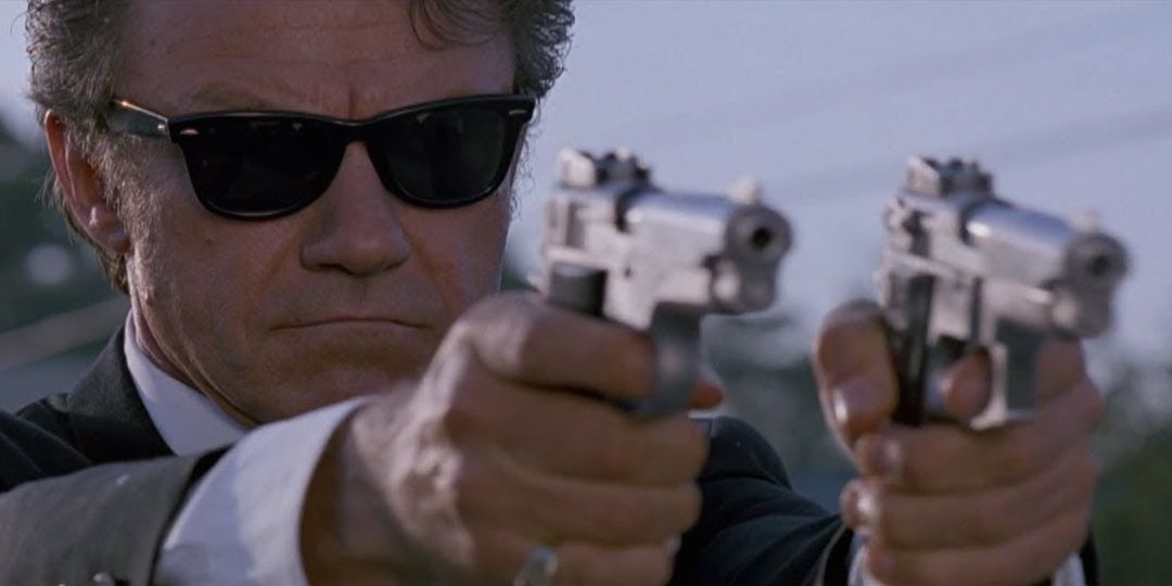 Mr White holding two guns in Reservoir Dogs