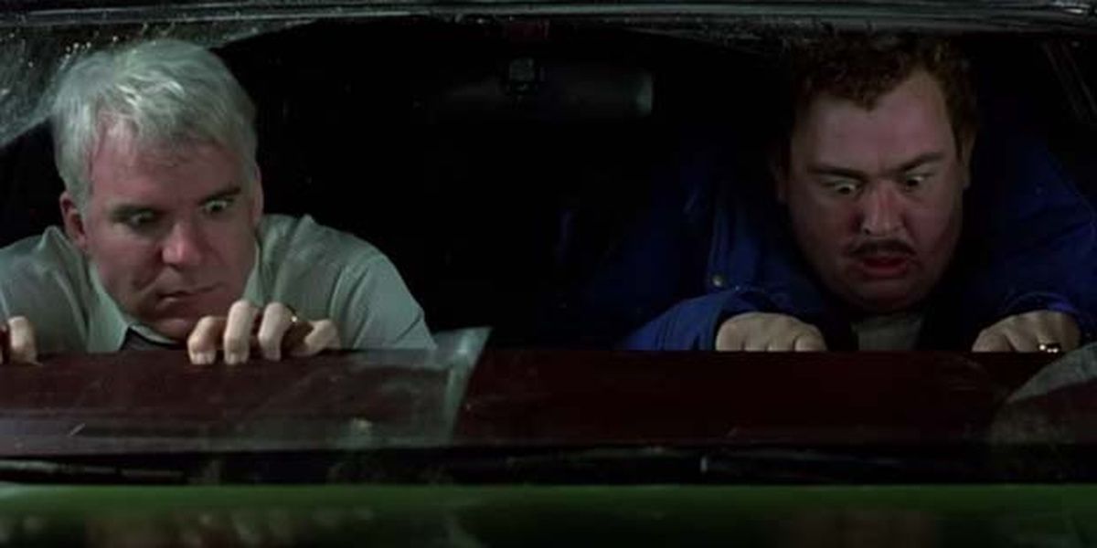 Neal and Del, their fingers stuck to the dashboard in Planes, Trains and Automobiles
