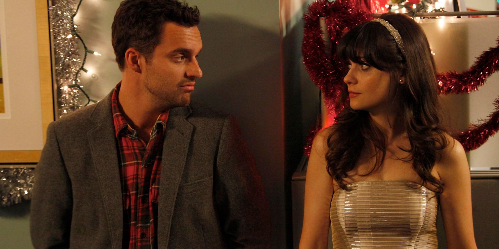 Nick and Jess stand against a holiday party and look at one another in New Girl S1E09 The 23rd