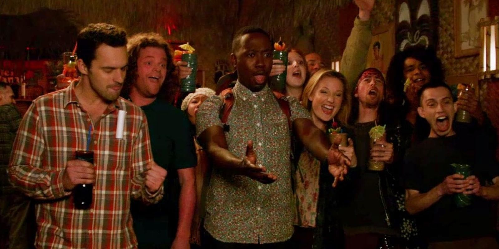Nick and Winston in a crowd in a bar in New Girl S4E15 The Crawl