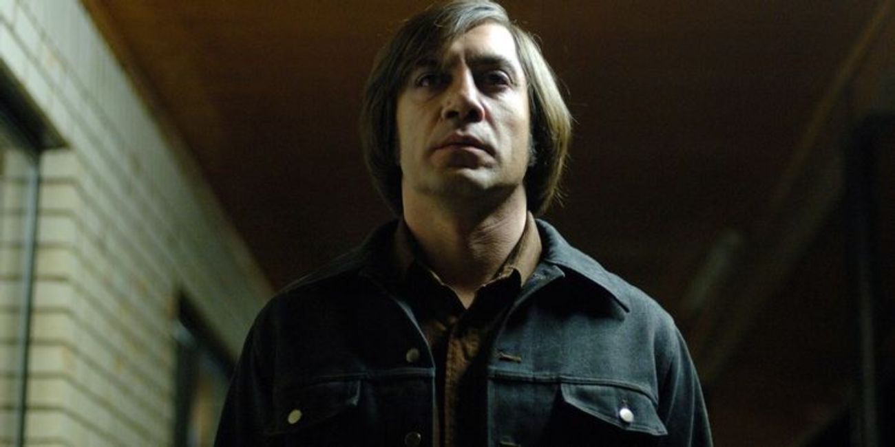 Javier Bardem as Anton Chigurh walking in the shadows in No Country for Old Men 2007