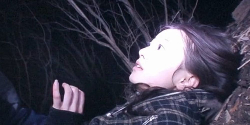 A young woman on the woods in Noroi The Curse (2005)
