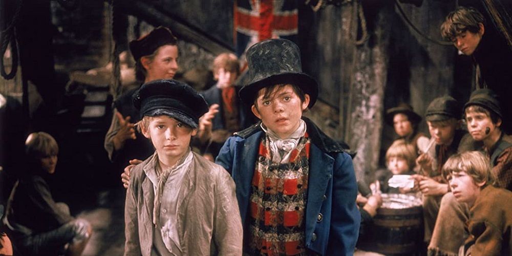 Oliver and his new friends stand amongst the orphans in Oliver!