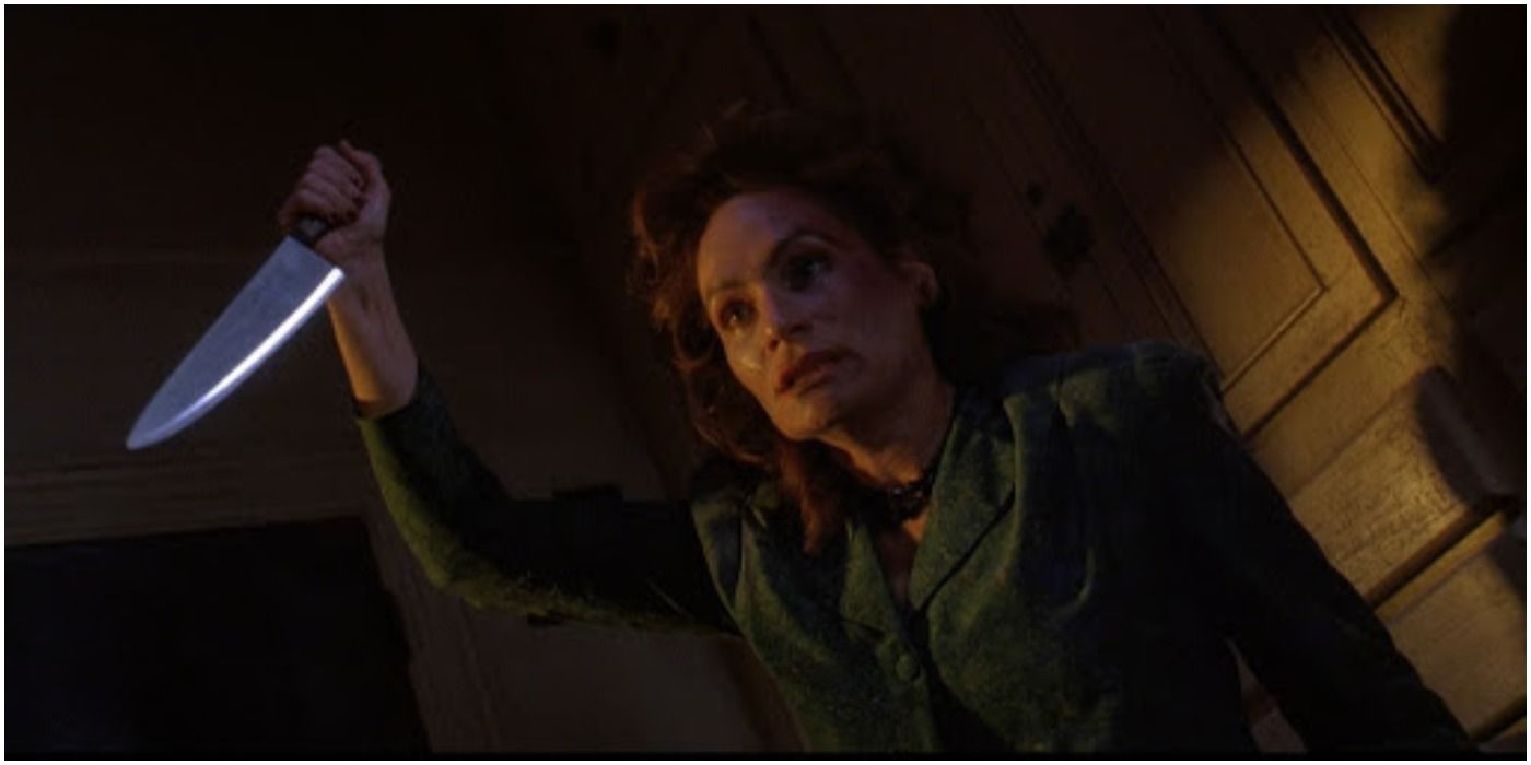 A woman wields a knife in The People Under the Stairs.