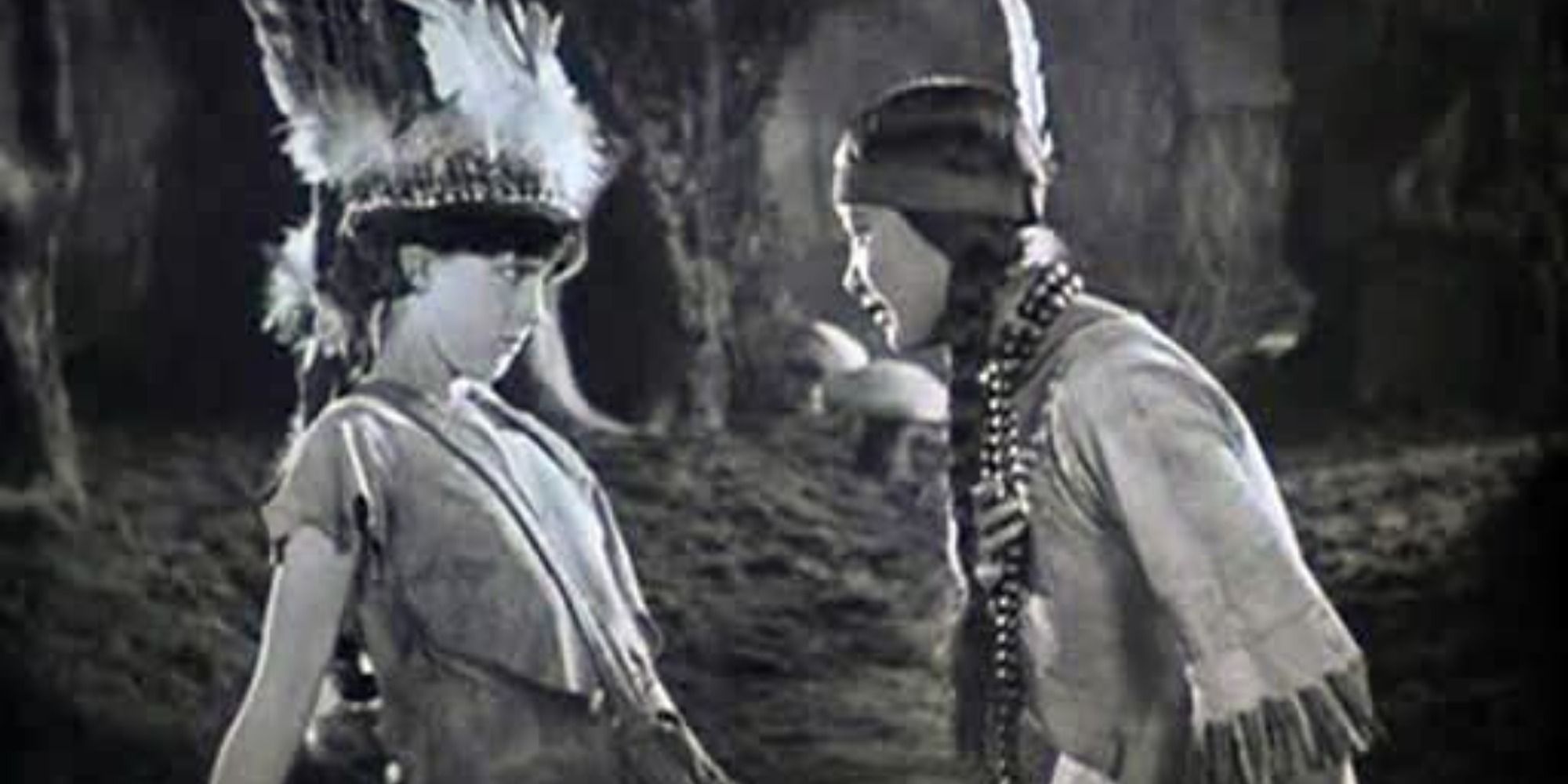 A screenshot of Betty Bronson's Peter Pan being smitten by Anna May Wong's Tiger Lily in Peter Pan (1924)