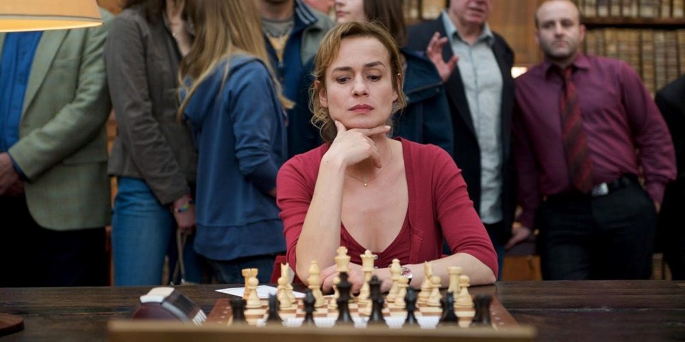 Actor sitting in behind a chess board in Queen to Play 2009