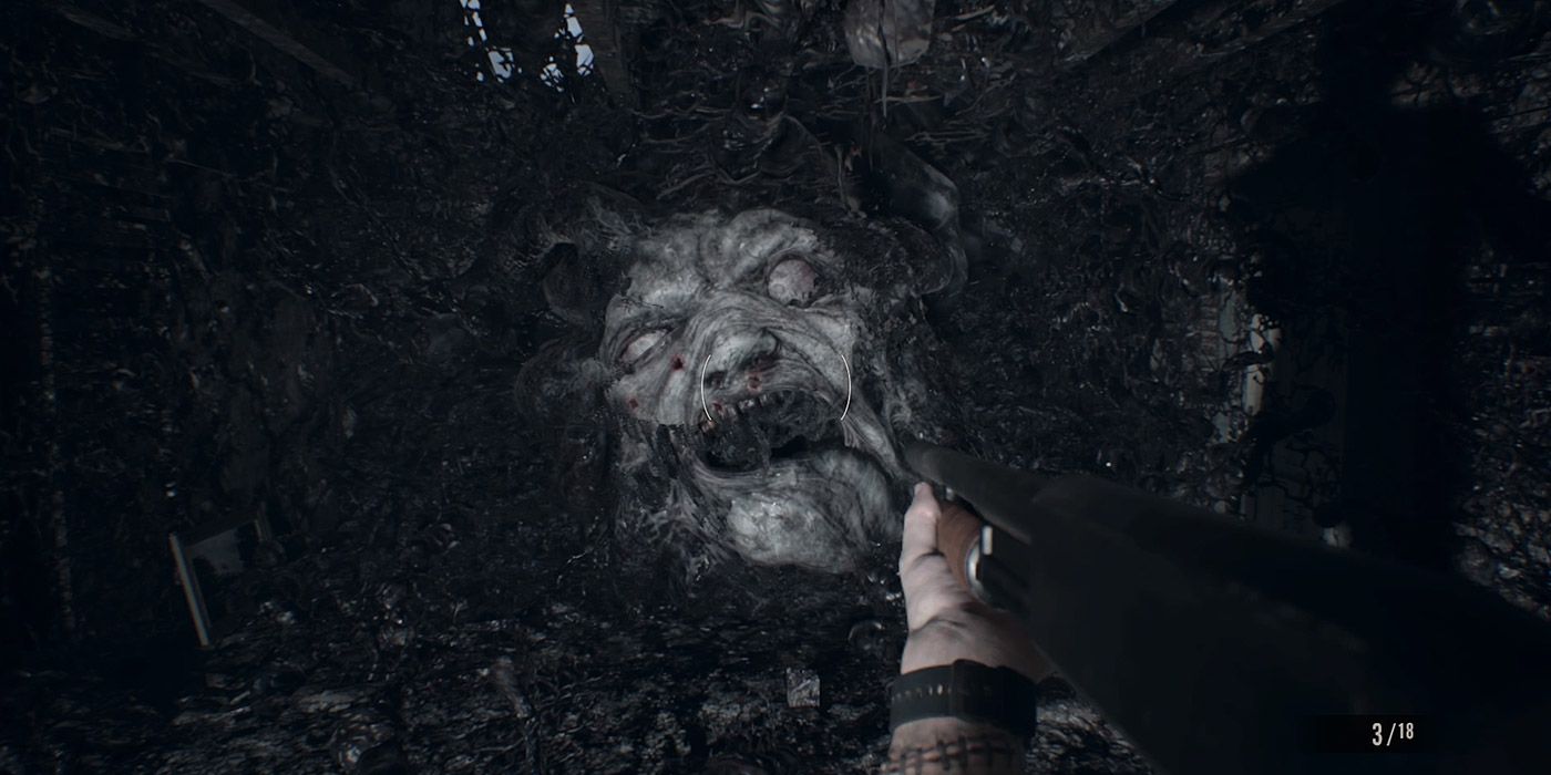 Ethan battles an evil face in a boss fight in Resident Evil VII