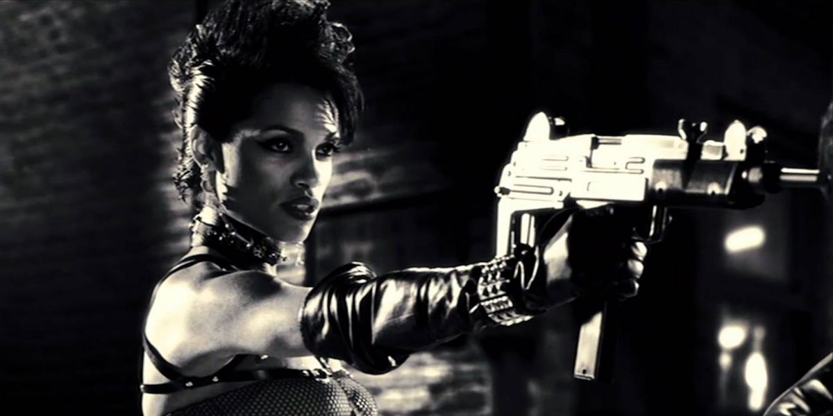Rosario Dawson holds a gun in Sin City