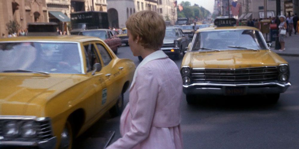 Rosemary walking in front of yellow taxis in Rosemary's Baby
