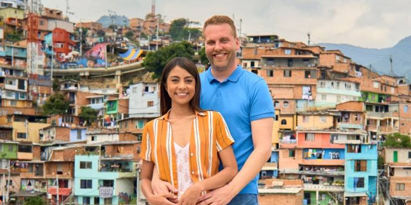 Tim Clarkson and Melyza Zeta from 90 Day Fiancé posing against Medellin background