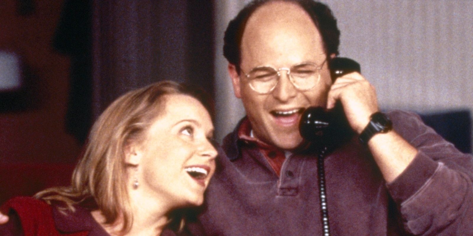 Susan smiles as George talks on the phone on Seinfeld