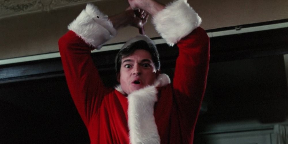 Ricky in a Santa suit holding a weapon over his head in Silent Night, Deadly Night Part 2 (1987)