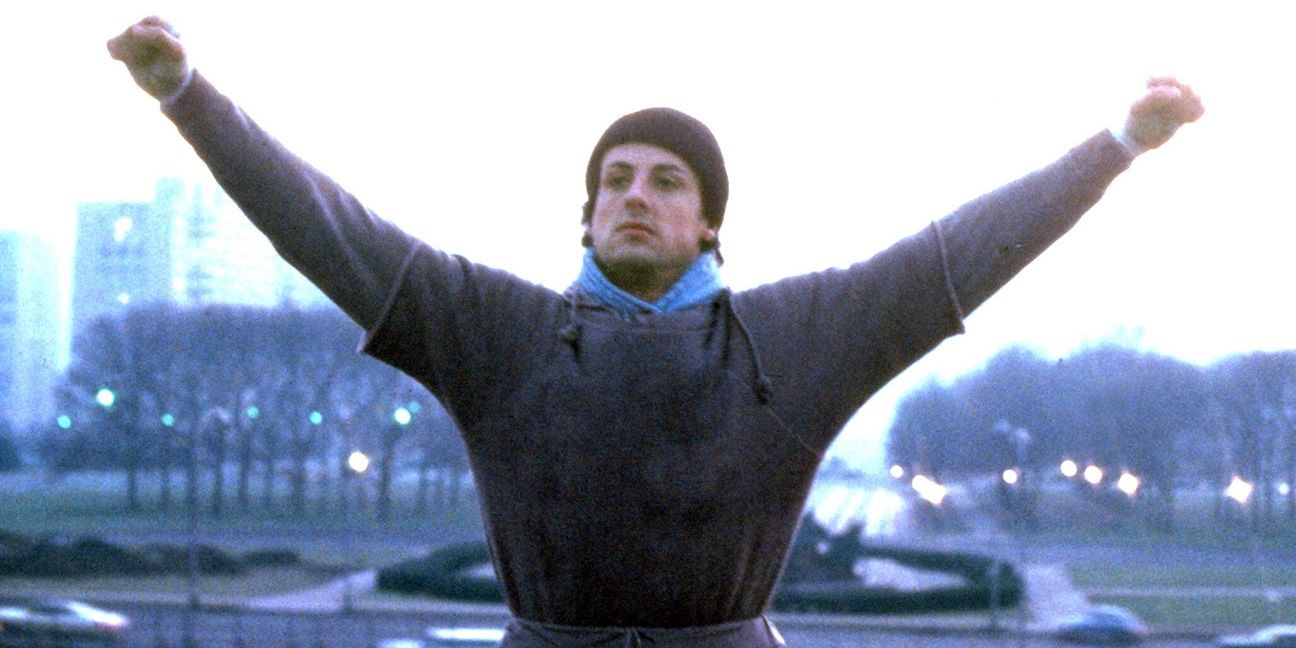 Sylvester Stallone, as Rocky Balboa, stands triumphant in Rocky