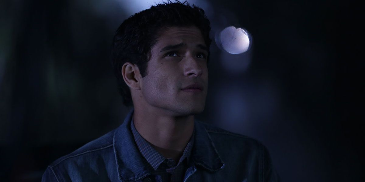 Scott looks up at the sky at night in Teen Wolf.