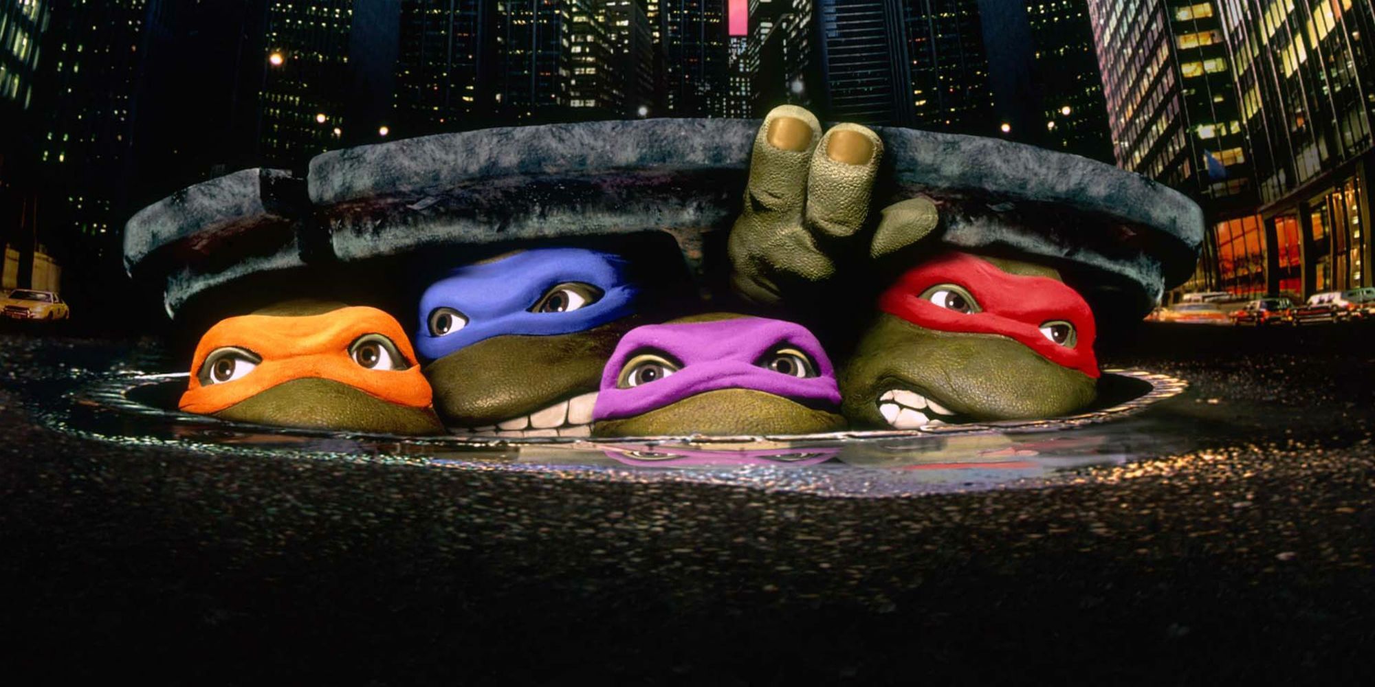 Teenage Mutant Ninja Turtles 1990 movie original poster of the turtles looking out of the sewer, cropped