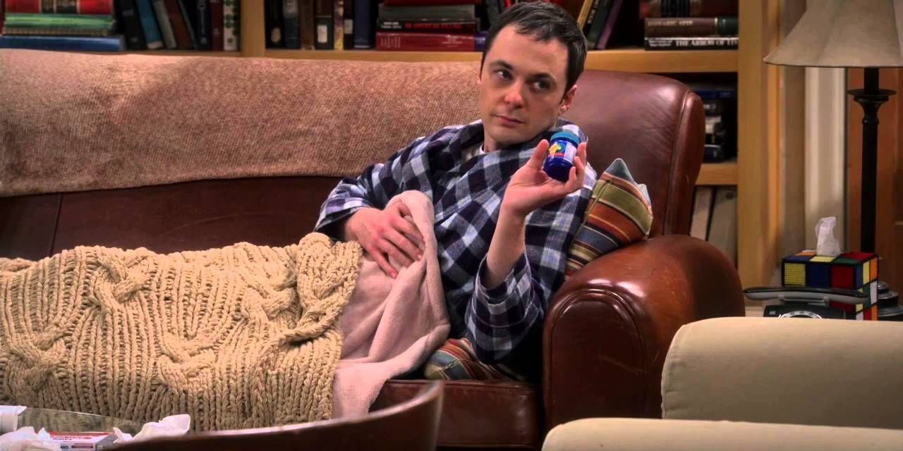 Sheldon sitting on the couch sick on TBBT