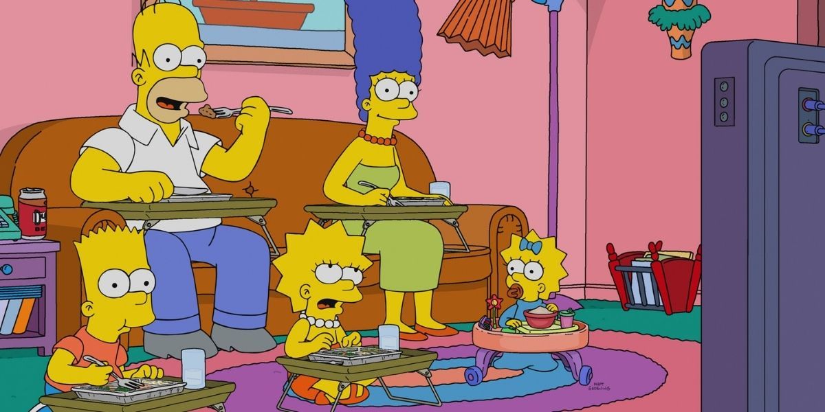 The Simpsons eating dinner in front of the TV