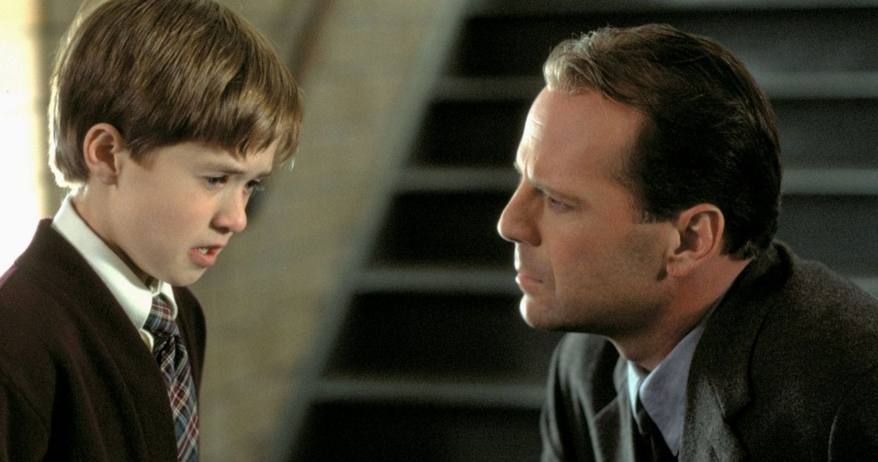 Malcolm leans down to Cole in The Sixth Sense