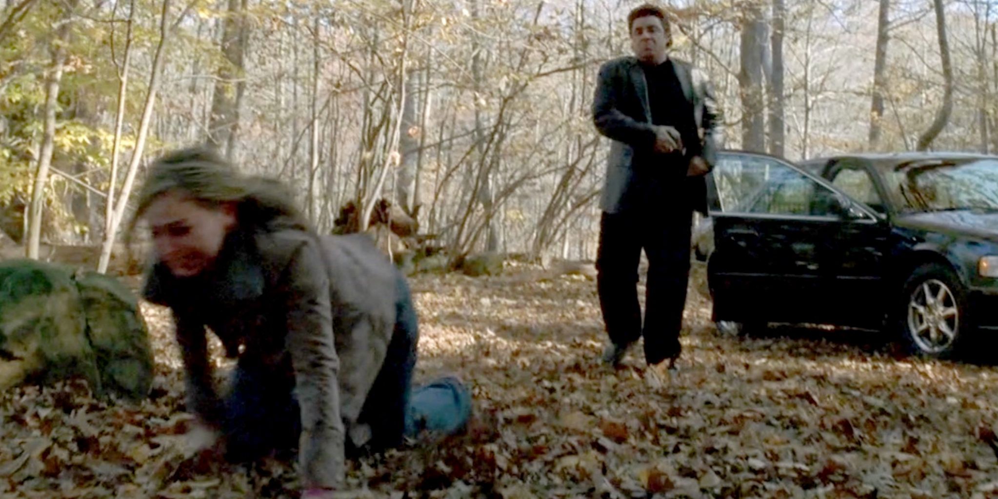 Adriana on her knees in a forest while Silvio attempts to shoot her in The Sopranos