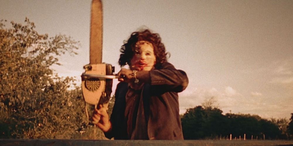 Leatherface wielding a chainsaw in The Texas Chain Saw Massacre (1974)
