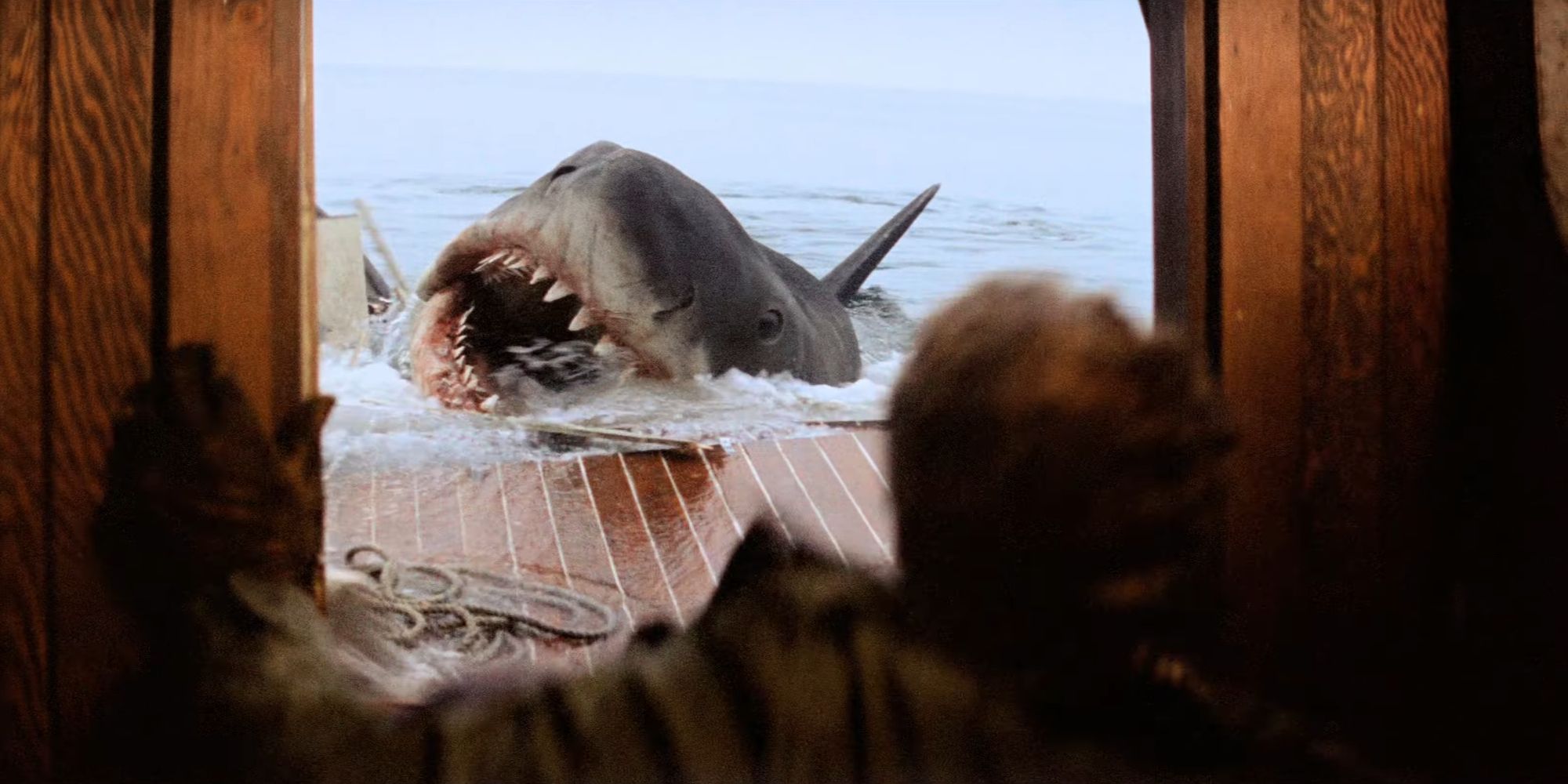 The shark on the Orca with Quint in the doorway in Jaws