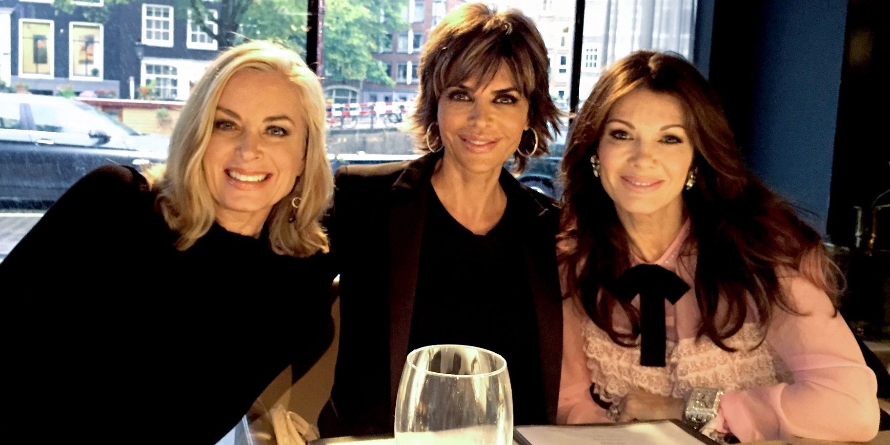 Eileen, Lisa, and Lisa smiling at dinner on an episode of RHOBH