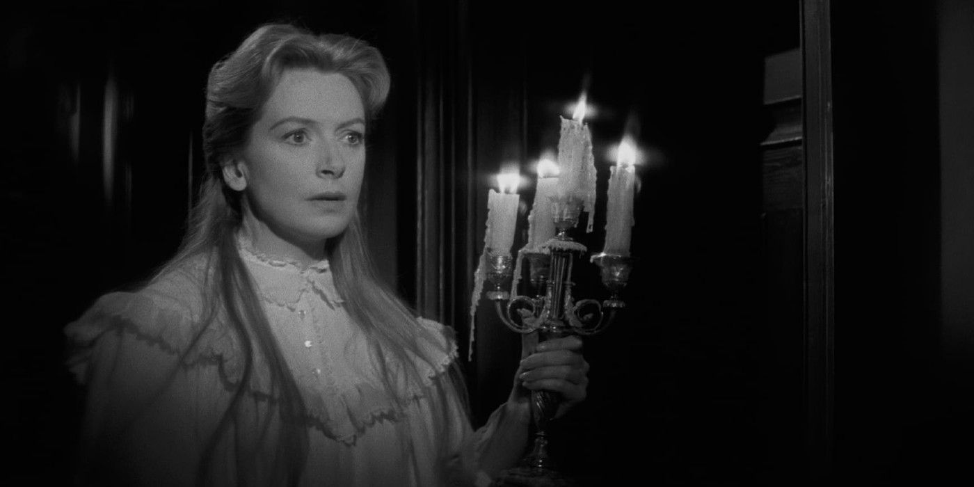 A woman holding a candelabra in The Innocents