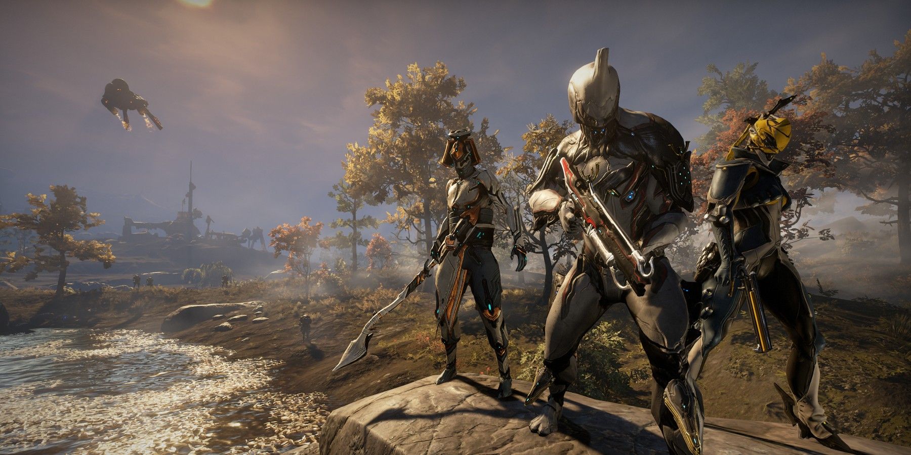 Three Tenno characters stand in the middle of a bleak location in Warframe.