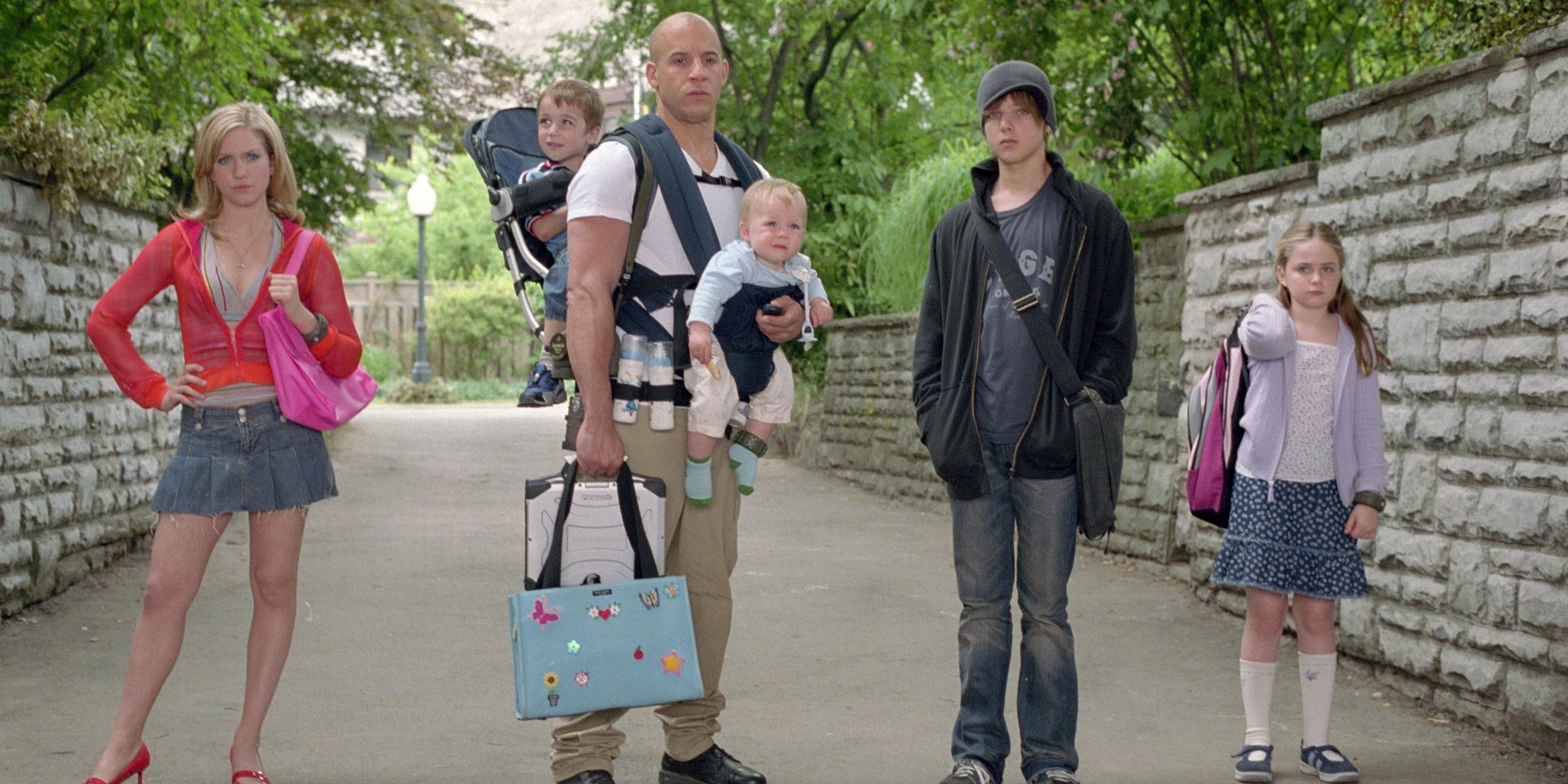 Vin Diesel standing with children in The Pacifier 