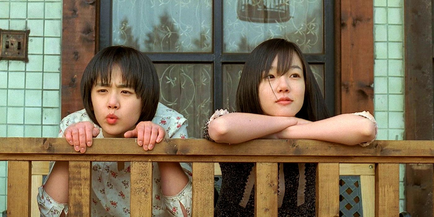 Sisters stand side by side and lean on a railing in Tale of Two Sisters.