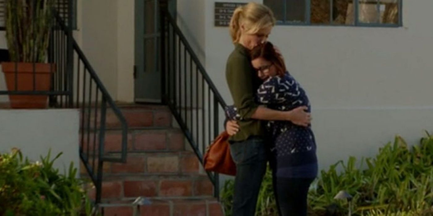 Alex and Claire hug outside on Modern Family
