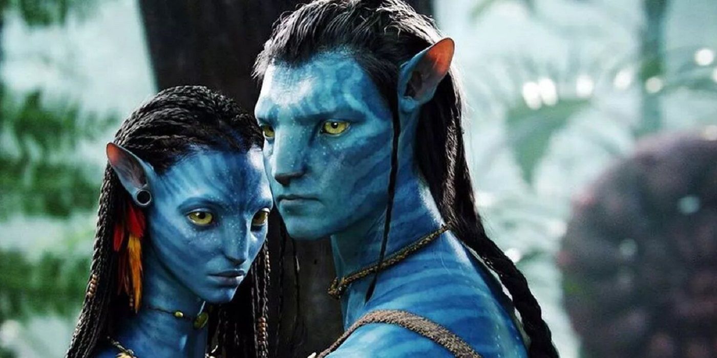 Sam Worthington as Jake Sully and Zoe Saldaña as Neytiri standing intimately close in the forest of Pandora in Avatar